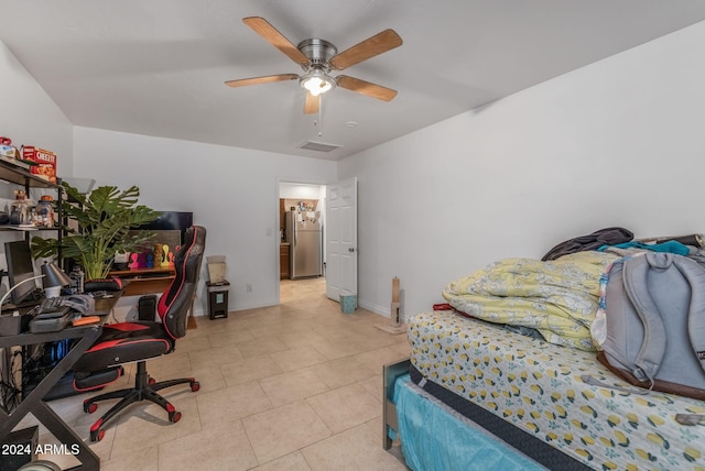 tiled bedroom with ceiling fan and stainless steel refrigerator