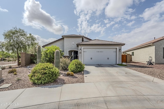 5759 W Saratoga Ct, Florence, AZ 85132 - view of front facade featuring stucco siding, driveway, fence, an attached garage, and a tile roof