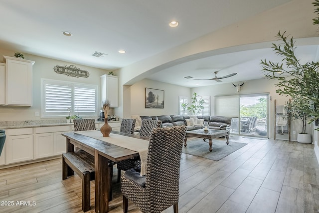5759 W Saratoga Ct, Florence, AZ 85132 - dining area with plenty of natural light, a ceiling fan, light wood-style flooring, arched walkways, and recessed lighting