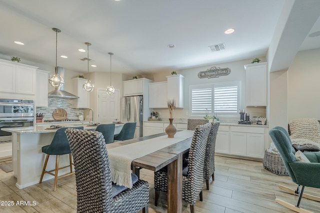 5759 W Saratoga Ct, Florence, AZ 85132 - dining space with light wood-style flooring and recessed lighting