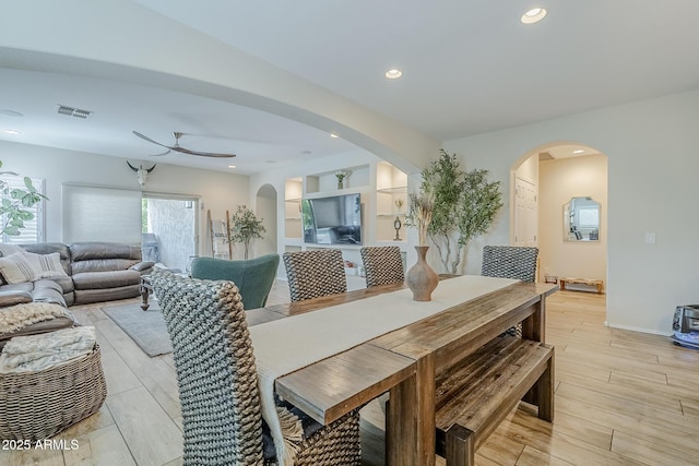 5759 W Saratoga Ct, Florence, AZ 85132 - dining space featuring a ceiling fan, light wood-style flooring, arched walkways, and recessed lighting