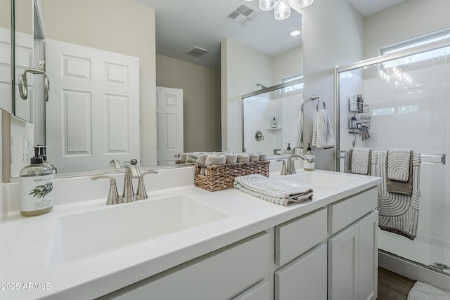 5759 W Saratoga Ct, Florence, AZ 85132 - full bathroom with a shower stall, double vanity, and wood finished floors