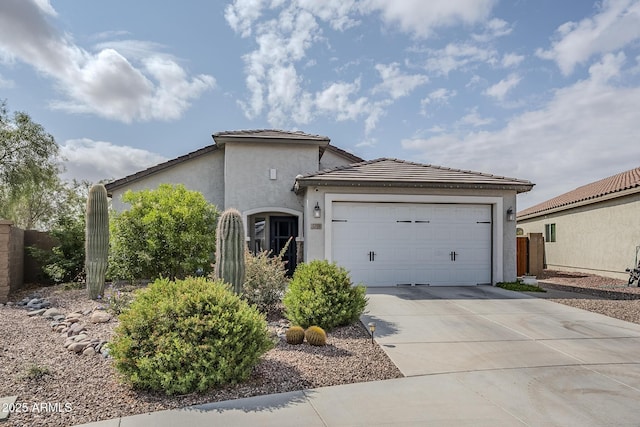 5759 W Saratoga Ct, Florence, AZ 85132 - view of side of property with driveway, an attached garage, stucco siding, a tiled roof, and fence
