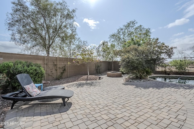 5759 W Saratoga Ct, Florence, AZ 85132 - view of patio / terrace featuring a fenced backyard and a fire pit