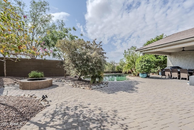 5759 W Saratoga Ct, Florence, AZ 85132 - fenced backyard with an outdoor fire pit, a patio area, an outdoor pool, and outdoor dining space