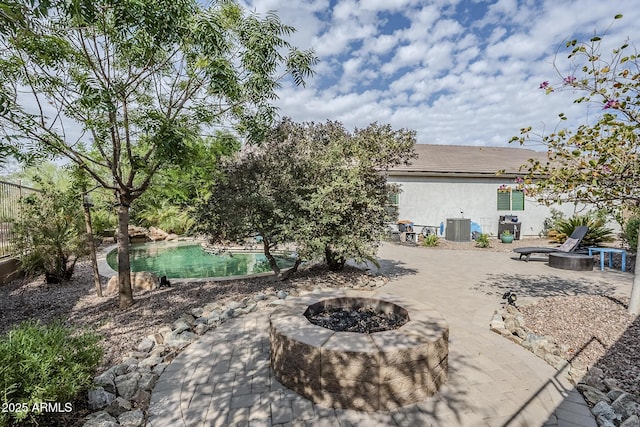 5759 W Saratoga Ct, Florence, AZ 85132 - view of yard featuring a fire pit, central air condition unit, a patio area, and an outdoor pool