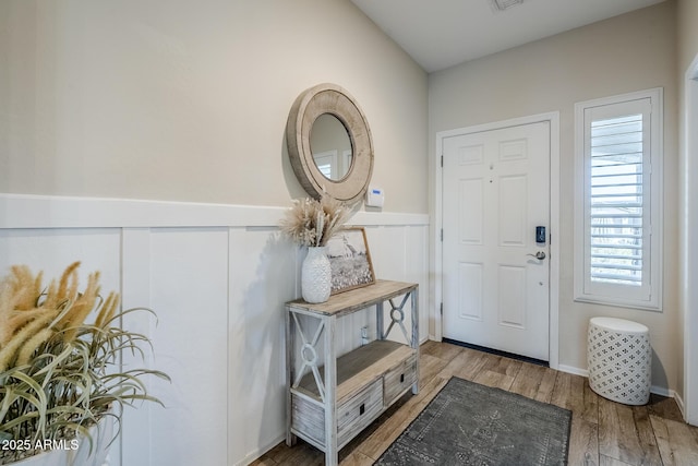 5759 W Saratoga Ct, Florence, AZ 85132 - entrance foyer featuring wood finished floors and a wainscoted wall
