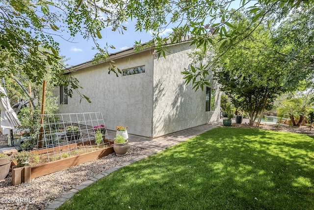 5759 W Saratoga Ct, Florence, AZ 85132 - view of green lawn featuring a garden