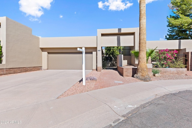 pueblo-style house with a garage