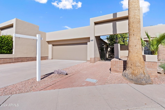 pueblo-style home with a garage