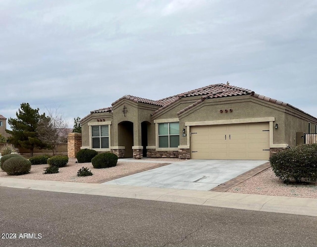 mediterranean / spanish-style home with a garage