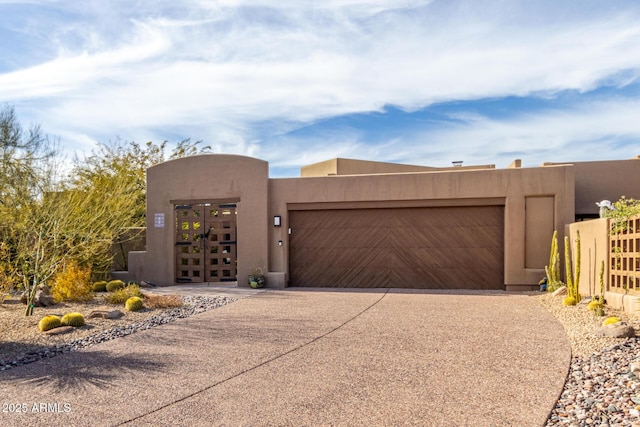 pueblo-style home featuring a garage