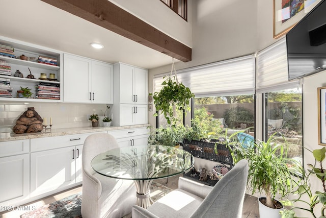 dining area with beamed ceiling