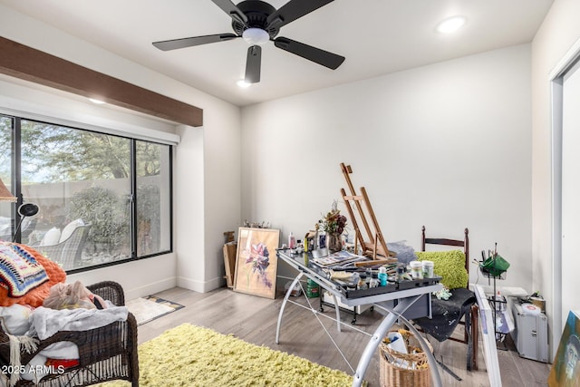 rec room with ceiling fan and light wood-type flooring