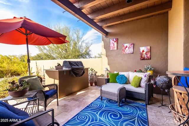 view of patio / terrace featuring an outdoor living space, a grill, and exterior kitchen