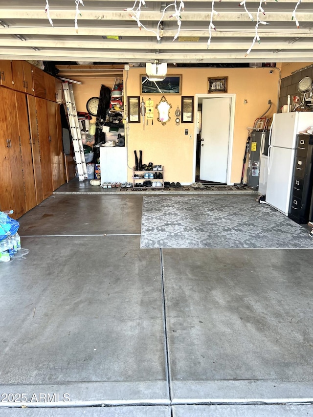 garage featuring white fridge and electric water heater