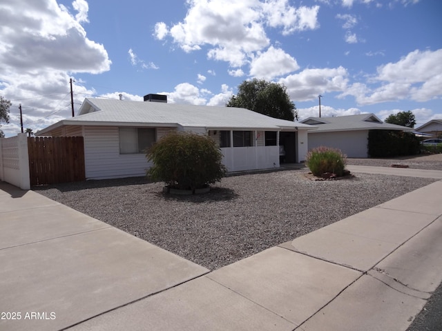 ranch-style house featuring fence, driveway, and an attached garage