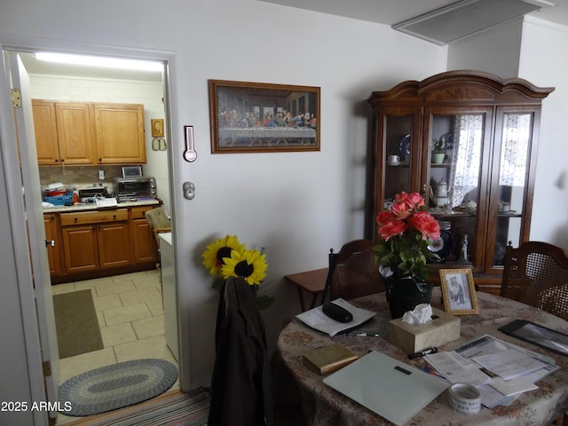 dining space featuring light tile patterned flooring