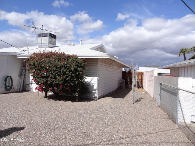 view of side of home with fence