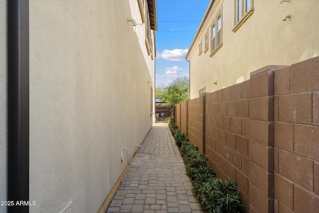 view of property exterior featuring fence and stucco siding