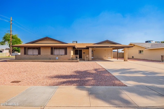 3901 W Augusta Ave, Phoenix, AZ 85051 - ranch-style home with concrete driveway, an attached carport, and brick siding