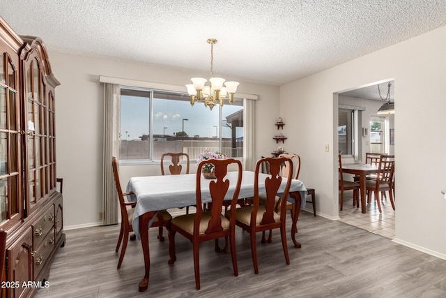 3901 W Augusta Ave, Phoenix, AZ 85051 - dining area with a chandelier, a textured ceiling, wood finished floors, and baseboards