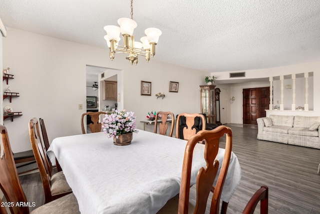 3901 W Augusta Ave, Phoenix, AZ 85051 - dining room featuring a chandelier, wood finished floors, and a textured ceiling