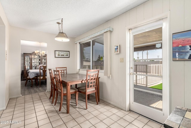 3901 W Augusta Ave, Phoenix, AZ 85051 - dining space featuring a chandelier, baseboards, a textured ceiling, and light tile patterned floors