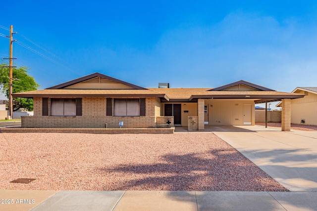 3901 W Augusta Ave, Phoenix, AZ 85051 - ranch-style house featuring concrete driveway, brick siding, and a carport