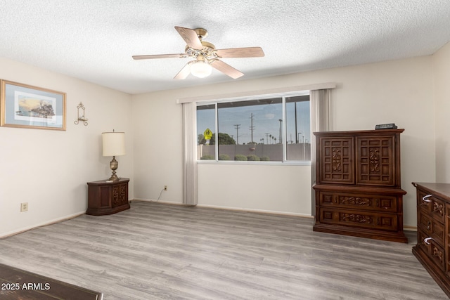 3901 W Augusta Ave, Phoenix, AZ 85051 - bedroom featuring wood finished floors, a textured ceiling, baseboards, and ceiling fan