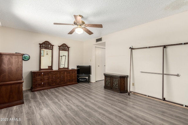 3901 W Augusta Ave, Phoenix, AZ 85051 - unfurnished bedroom with wood finished floors, a textured ceiling, ceiling fan, and baseboards