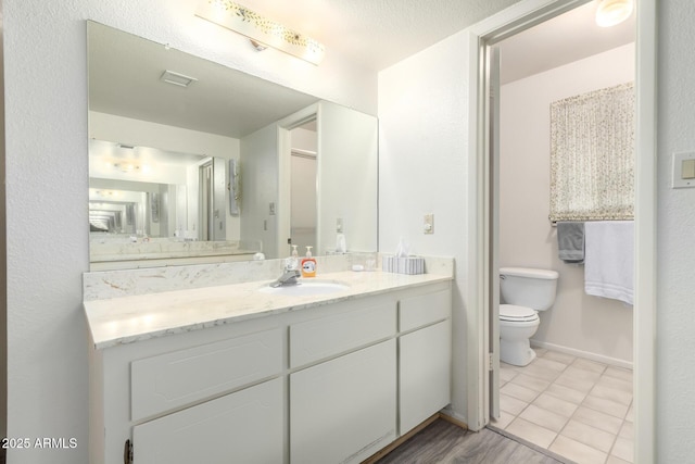 3901 W Augusta Ave, Phoenix, AZ 85051 - bathroom with toilet, vanity, and baseboards