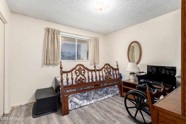 3901 W Augusta Ave, Phoenix, AZ 85051 - bedroom featuring wood finished floors, a textured ceiling, and an office area