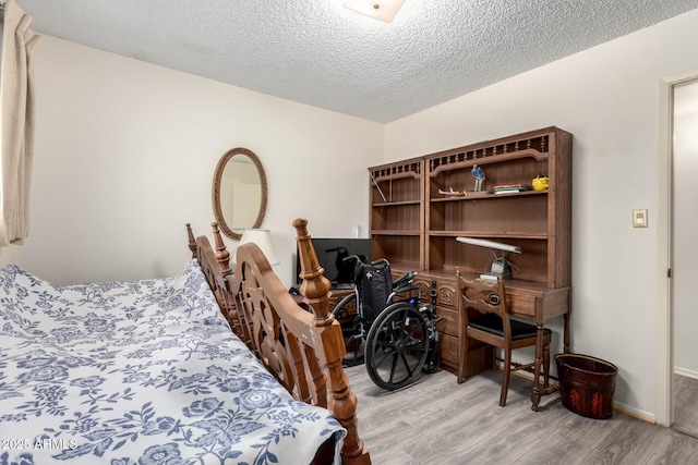 3901 W Augusta Ave, Phoenix, AZ 85051 - bedroom with light wood-style flooring, an office area, a textured ceiling, and baseboards