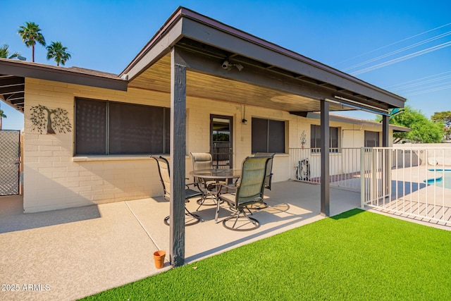 3901 W Augusta Ave, Phoenix, AZ 85051 - rear view of property featuring a patio, fence, and concrete block siding