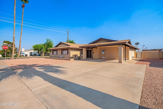 3901 W Augusta Ave, Phoenix, AZ 85051 - single story home featuring a carport, driveway, fence, brick siding, and roof with shingles