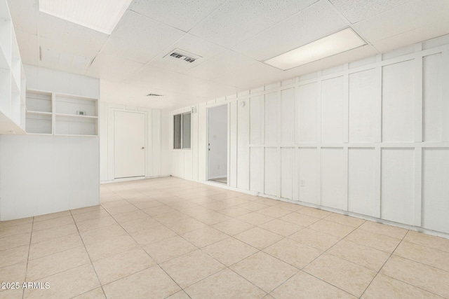 spare room featuring visible vents and a drop ceiling