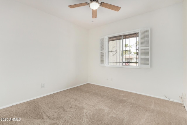 spare room featuring carpet, baseboards, and a ceiling fan