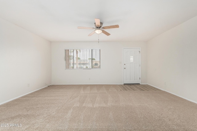 empty room with light carpet, ceiling fan, and baseboards