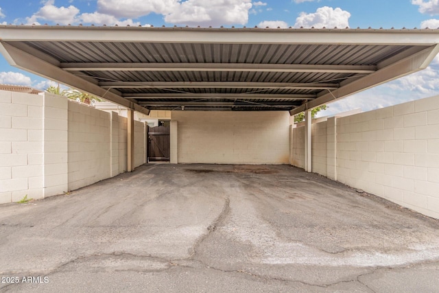 view of patio featuring a carport, fence, and a gate