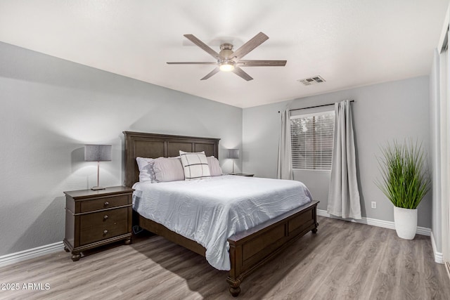 bedroom with light hardwood / wood-style floors and ceiling fan