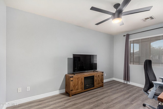 office space with ceiling fan and light hardwood / wood-style flooring