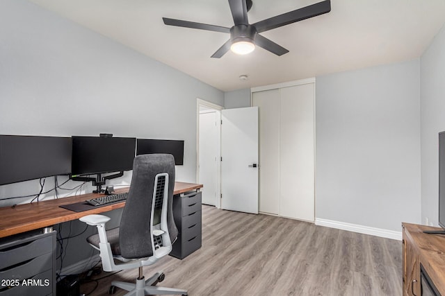 home office featuring ceiling fan and light hardwood / wood-style flooring