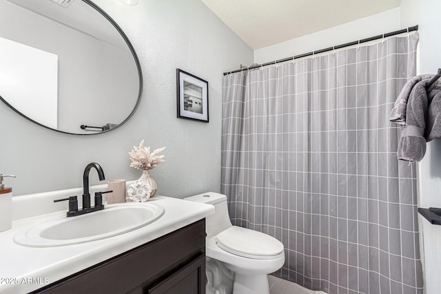 bathroom featuring vanity, a shower with curtain, and toilet