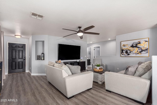 living room featuring hardwood / wood-style floors and ceiling fan