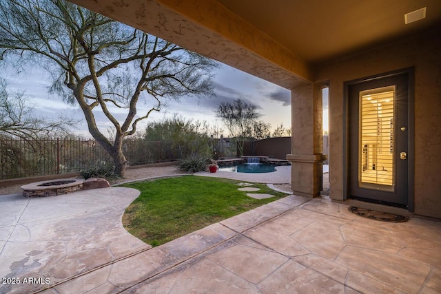 exterior space featuring a fenced in pool, a lawn, a fenced backyard, and an outdoor fire pit