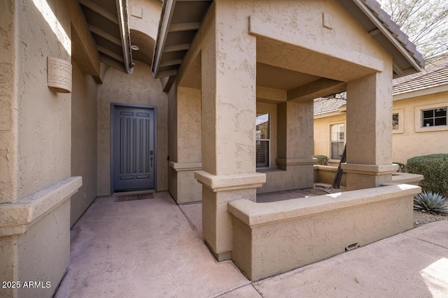 property entrance featuring stucco siding