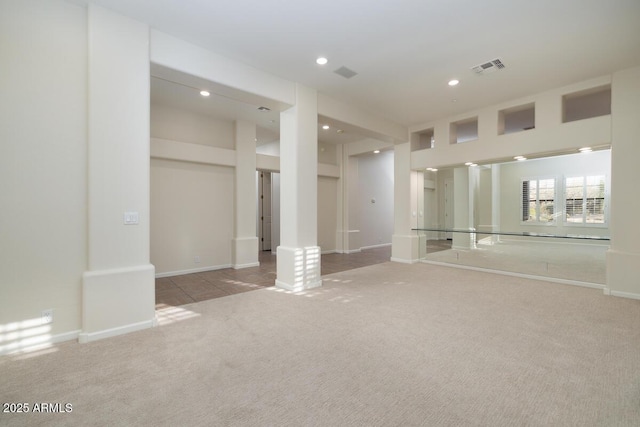 unfurnished room with recessed lighting, visible vents, baseboards, and carpet