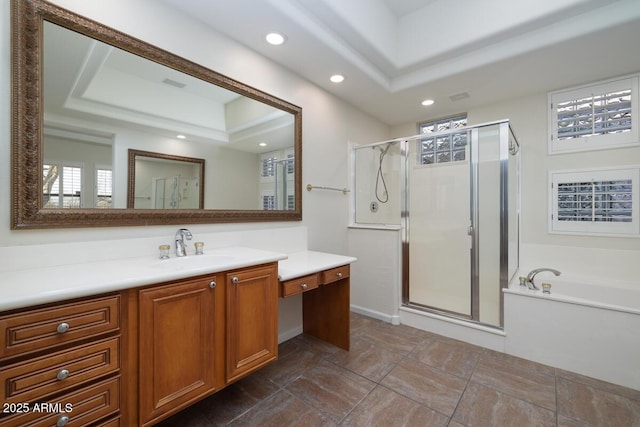 full bathroom featuring a shower stall, a tray ceiling, recessed lighting, a bath, and vanity