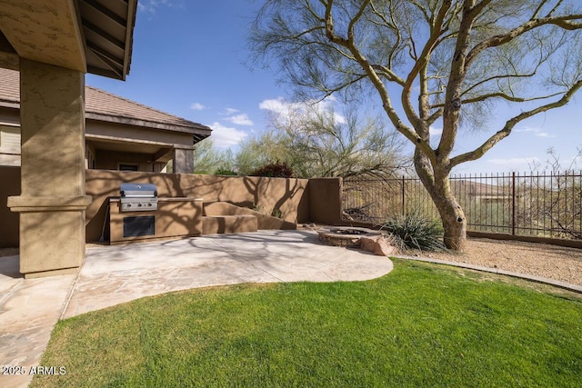 view of yard with a patio area, a fire pit, area for grilling, and fence